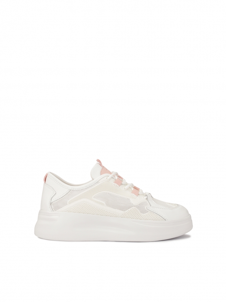 Ladies’ white sporty shoes on a thick sole