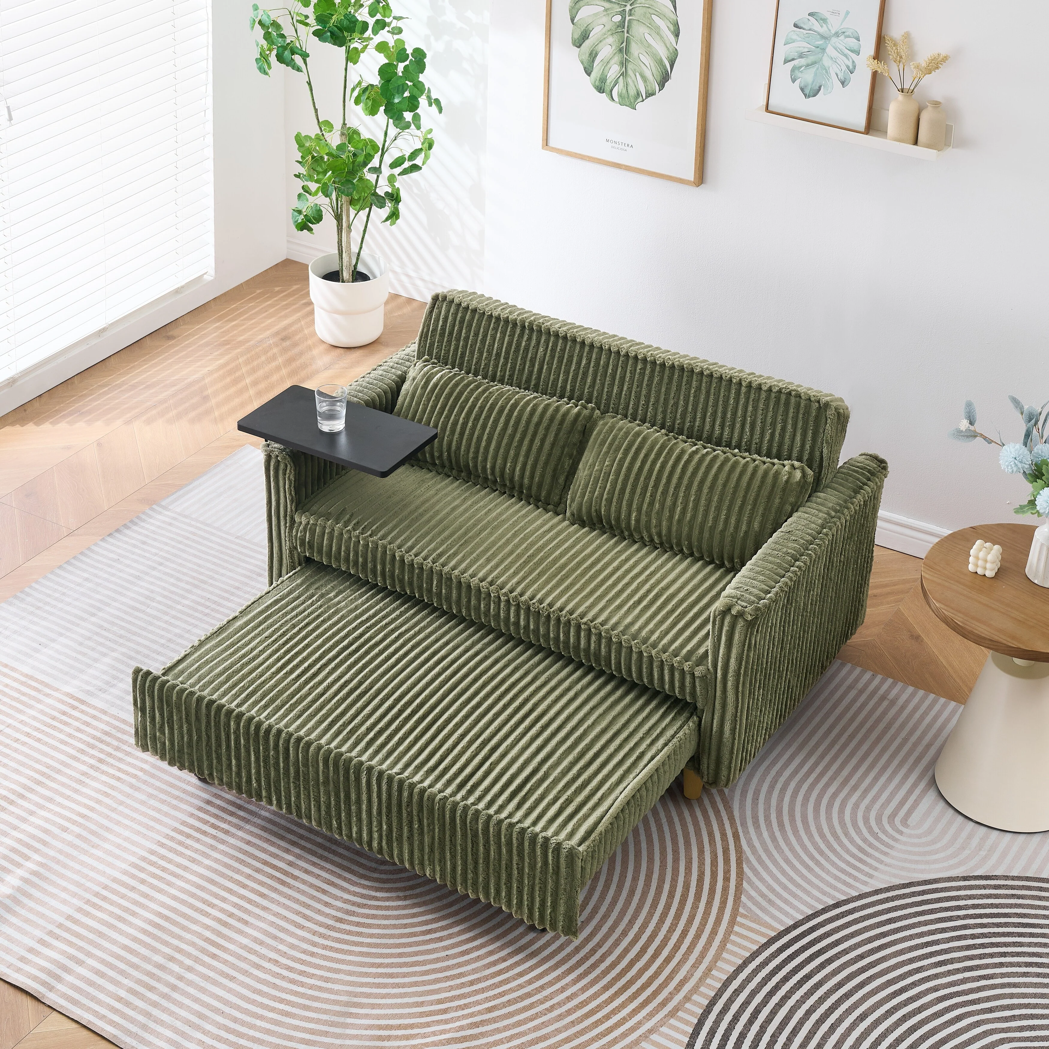 The pull-out and push-in green corduroy sofa with dual functions, equipped with a movable tabletop and USB ports