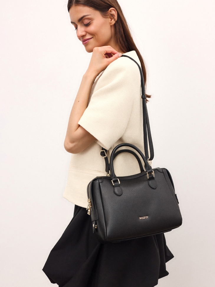 Sleek handbag with handles and strap