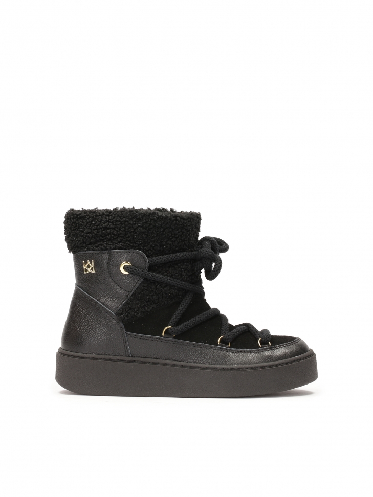 Black snow boots made of combined materials