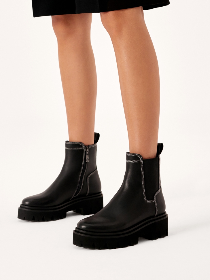 Black boots with white stitching
