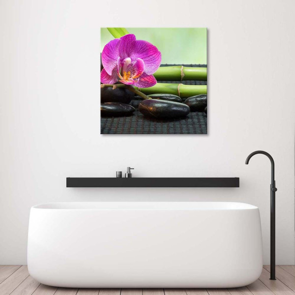 Feeby Obraz na płótnie Kwitnąca orchidea na kamieniach 30x30