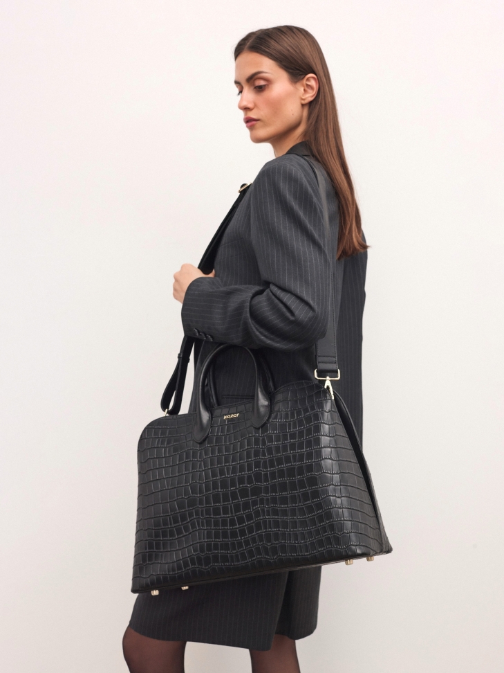 Black elegant handbag with embossed pattern
