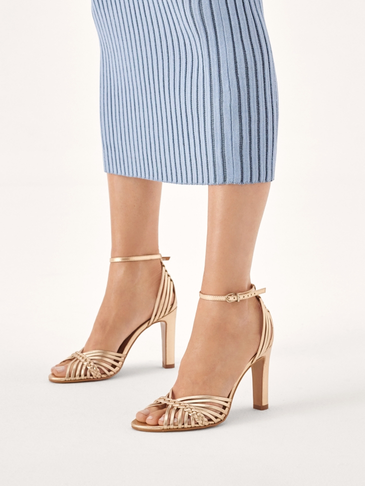 Golden sandals with woven straps