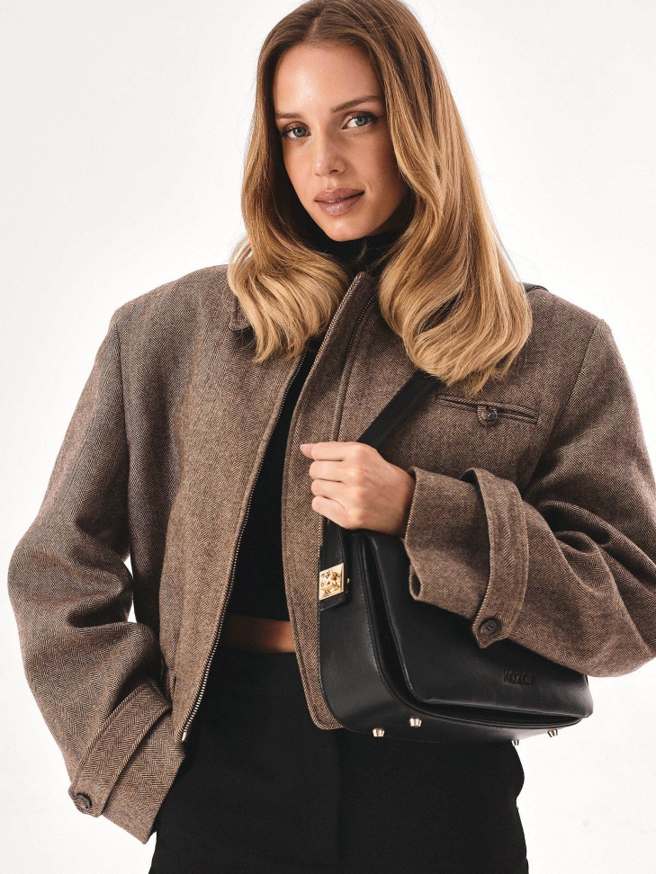 Black handbag with striking pinned strap