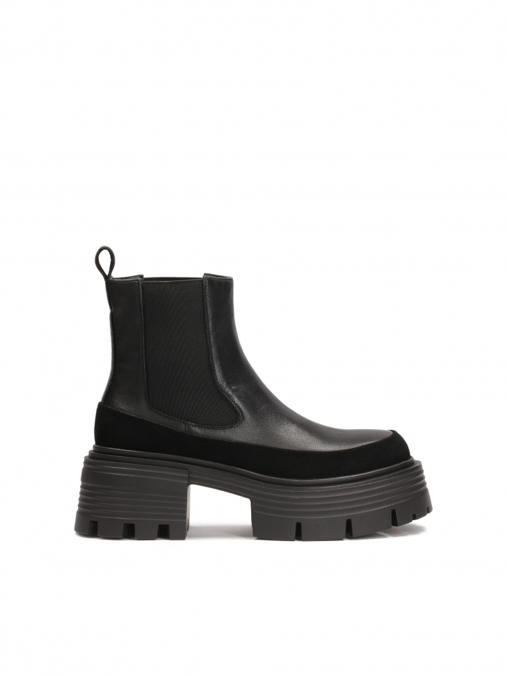 Black Chelsea boots on an elevated sole with embossing