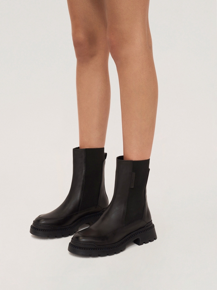 Chelsea-type leather booties on a thick, futuristic sole
