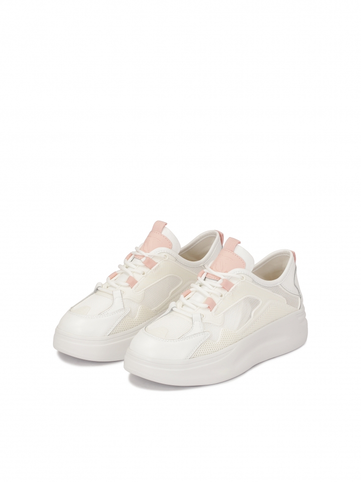 Ladies’ white sporty shoes on a thick sole