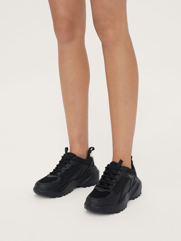Ladies’ leather sneakers on a thick sole