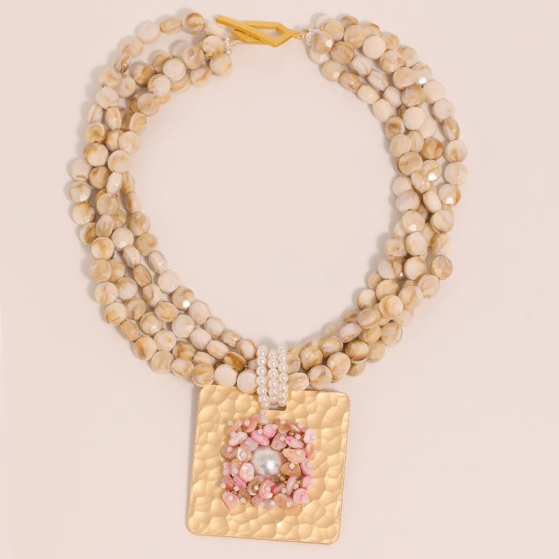PEACH ACCESSORIES Shell Beaded Choker with Bold Gold Tone Medallion in Cream