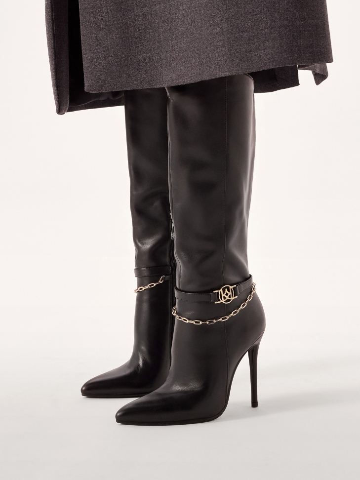 Black high stiletto boots with decorative chain