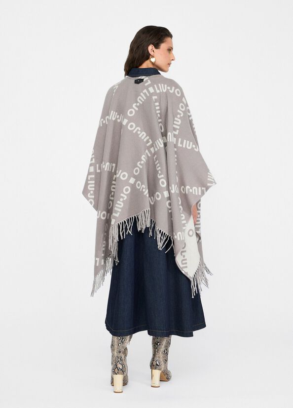 Poncho con logo e frange
