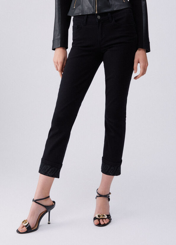 Pantaloni skinny con risvolto e strass