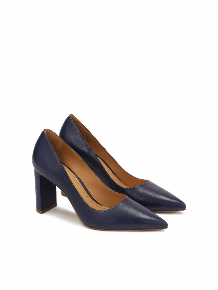 Navy blue pumps on a post with pointed toe noses