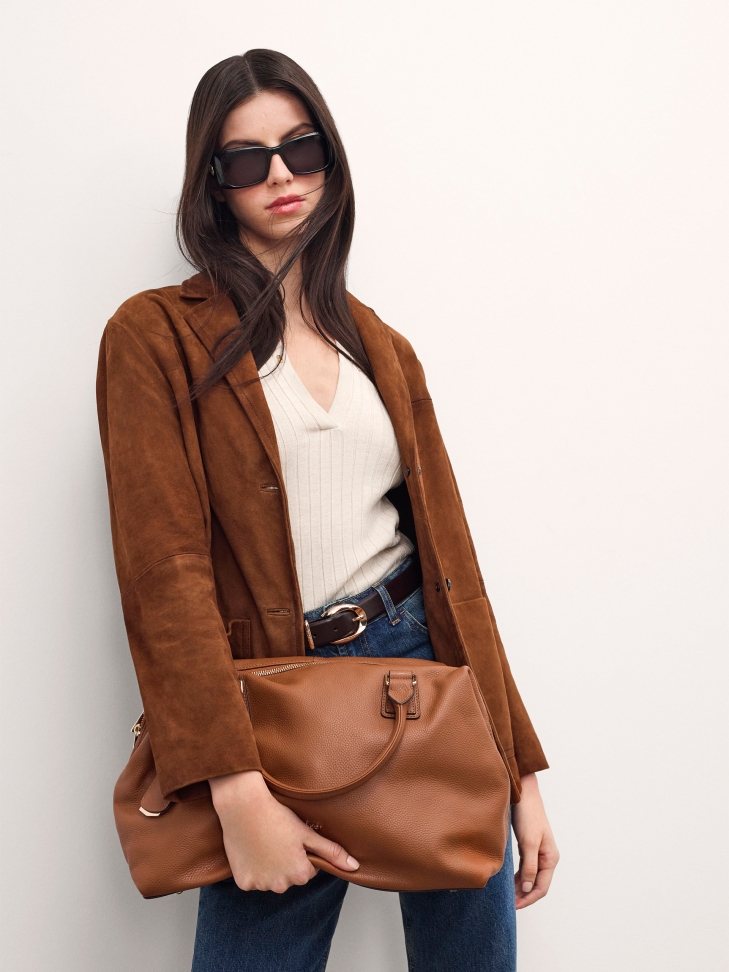 Large light brown handbag with two handles and a strap