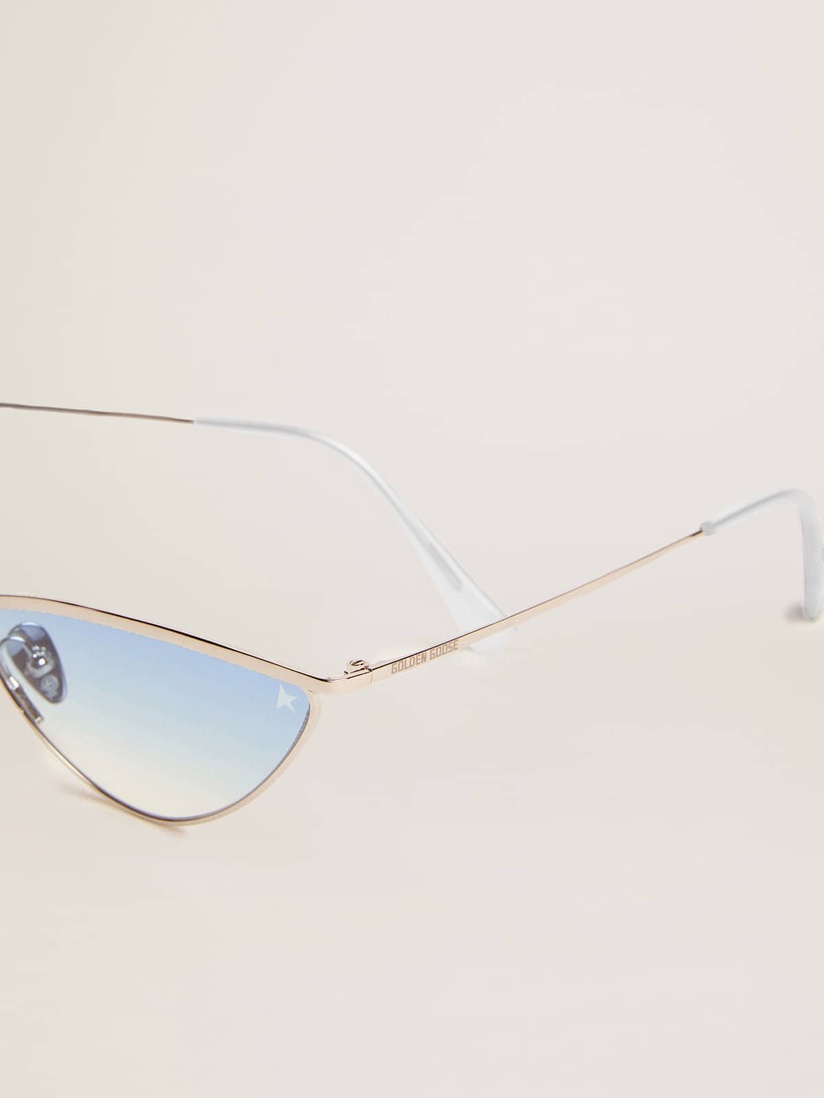 Sunglasses cat-eye style with silver frame and blue lenses
