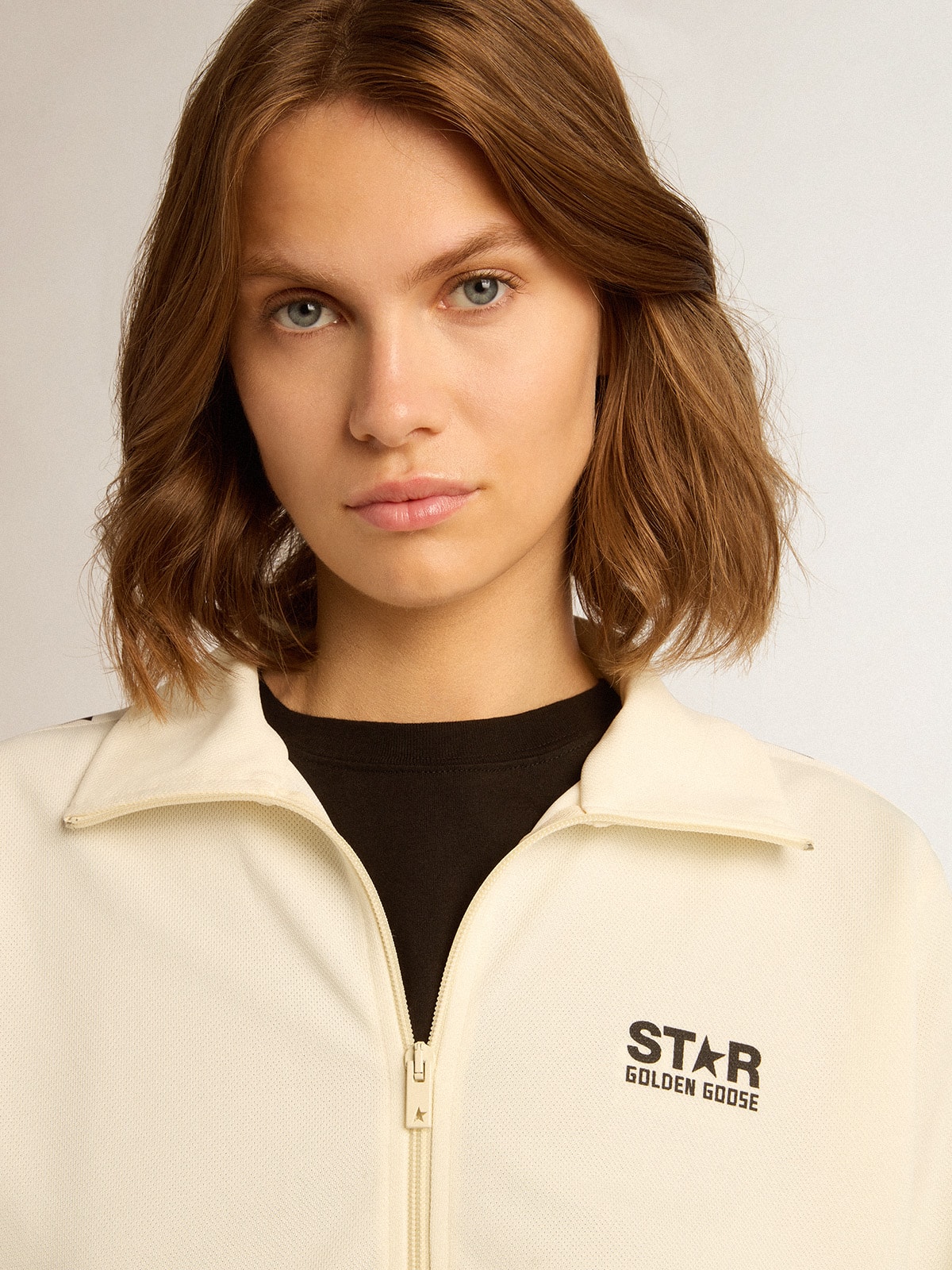 Women's white zipped sweatshirt with white strip and black stars
