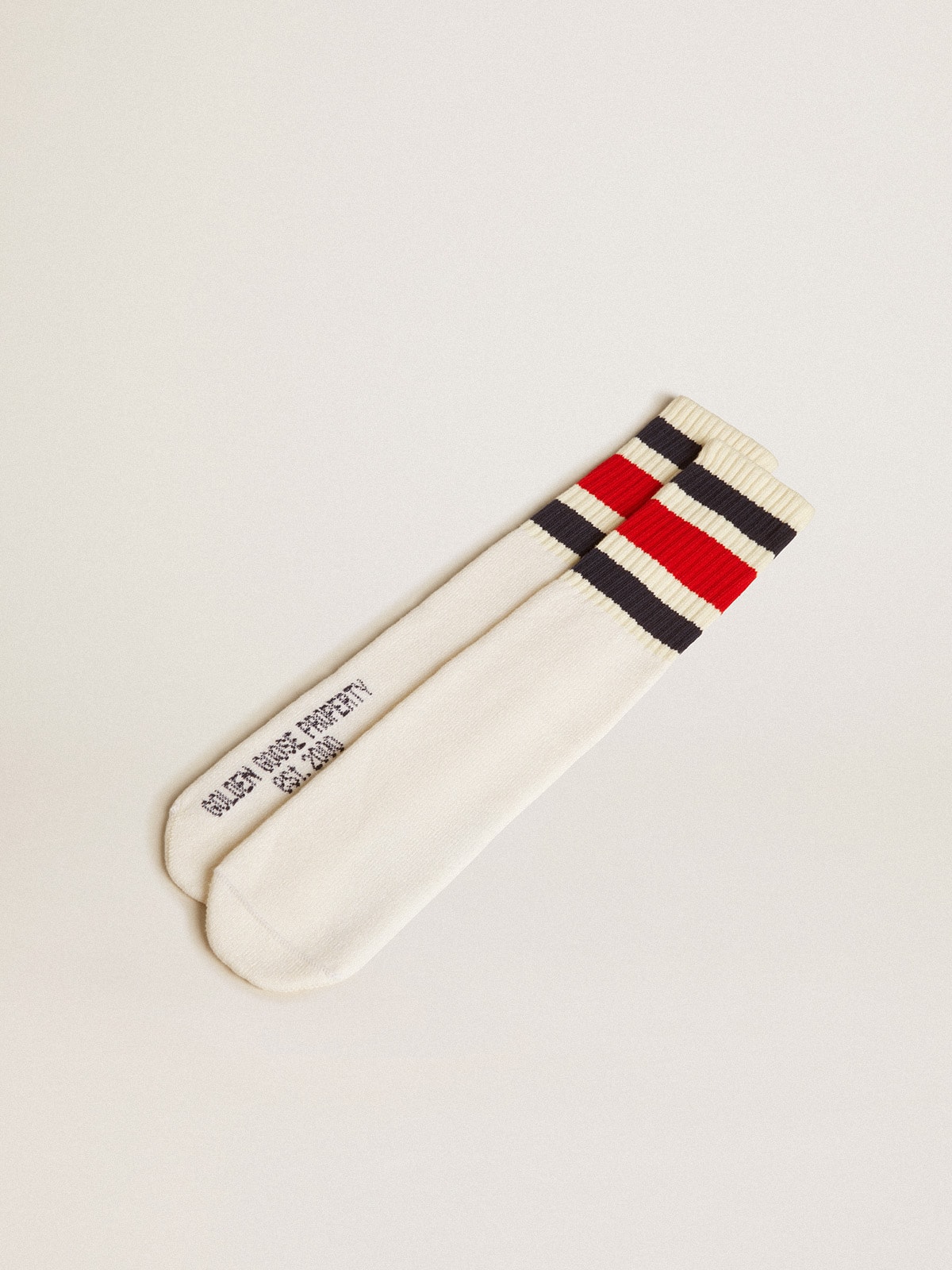 Worn-white socks with black and red stripes