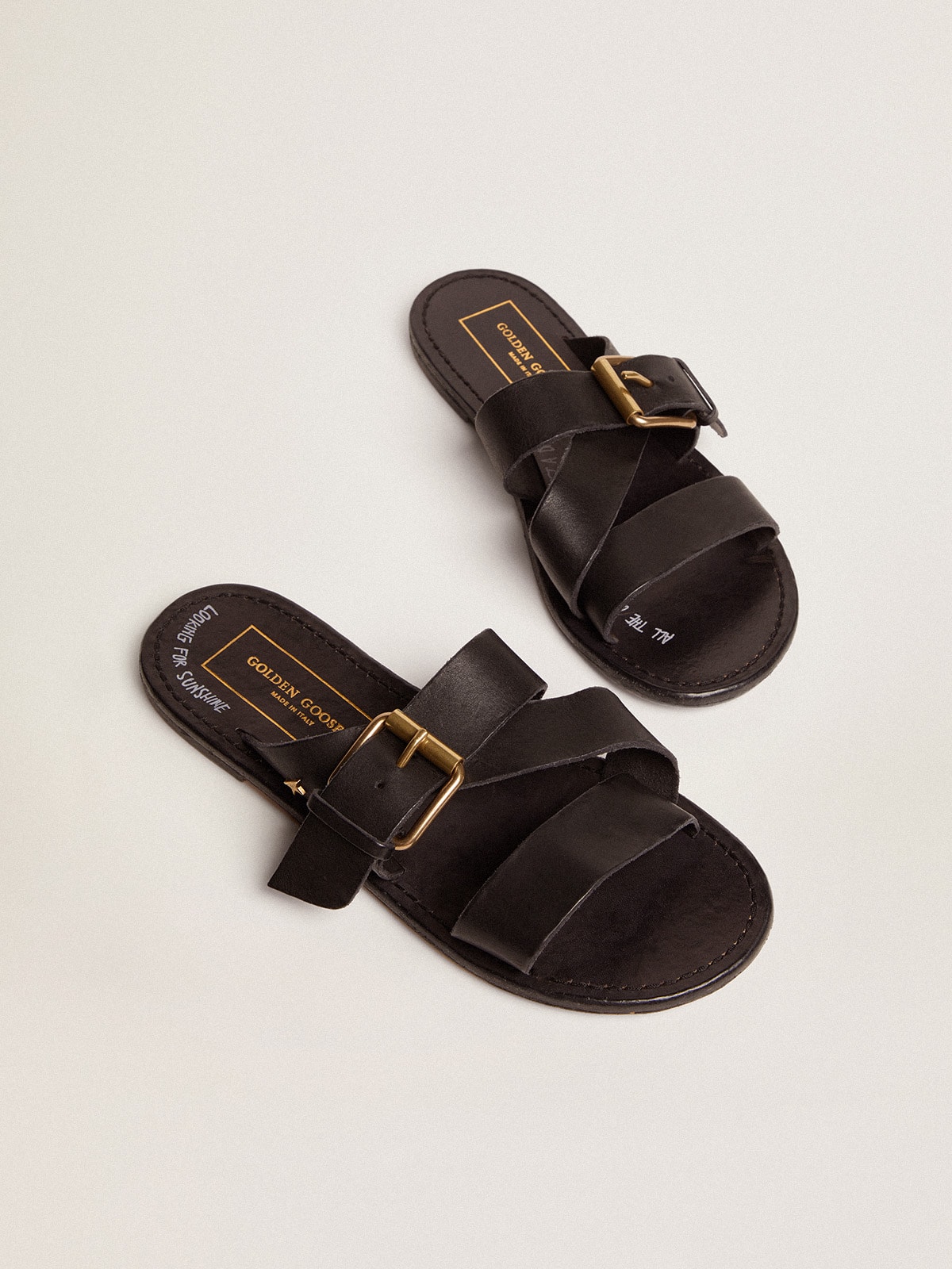 Women's Margaret flat sandals in black resin-coated leather
