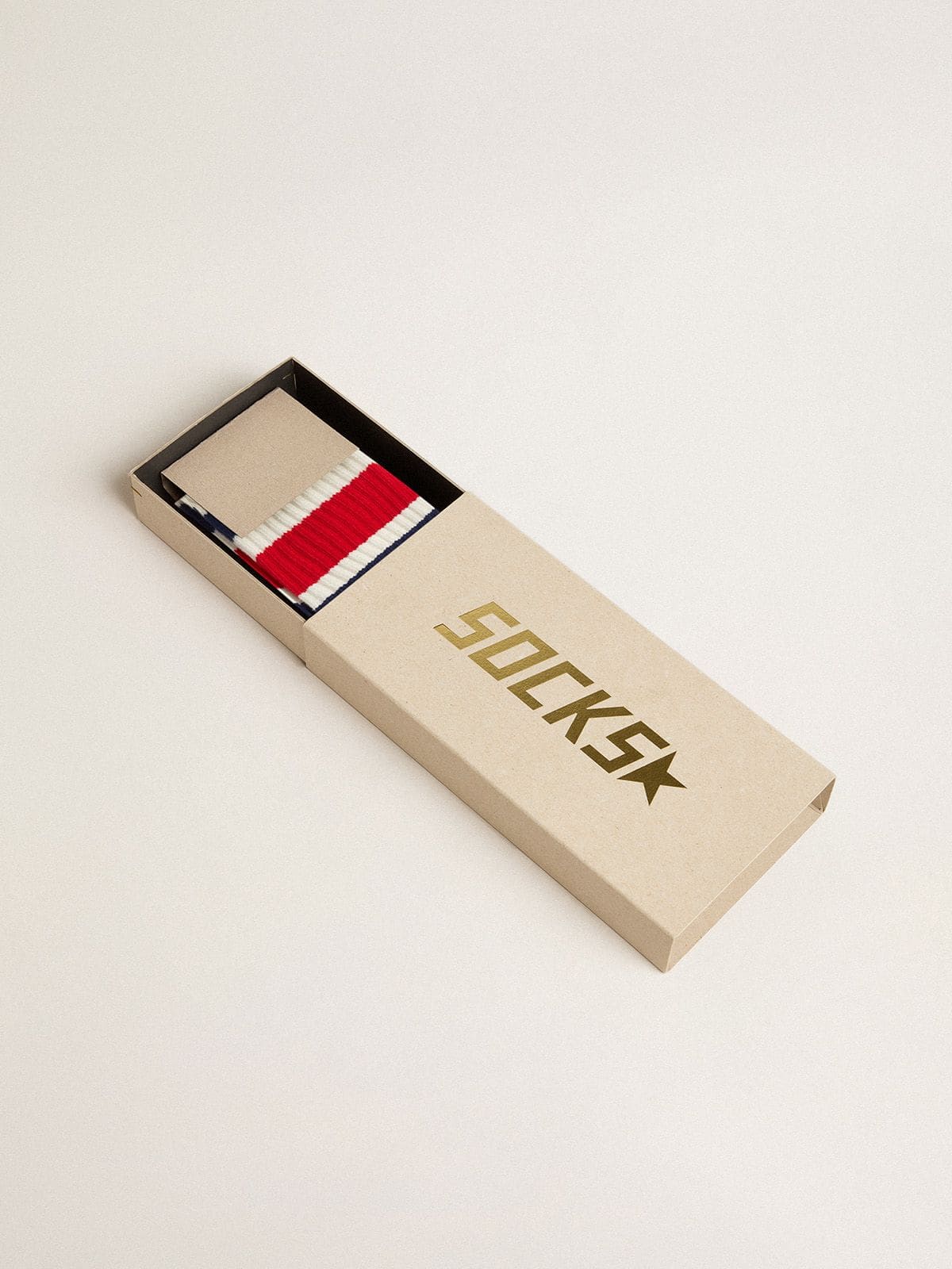 Worn-white socks with black and red stripes