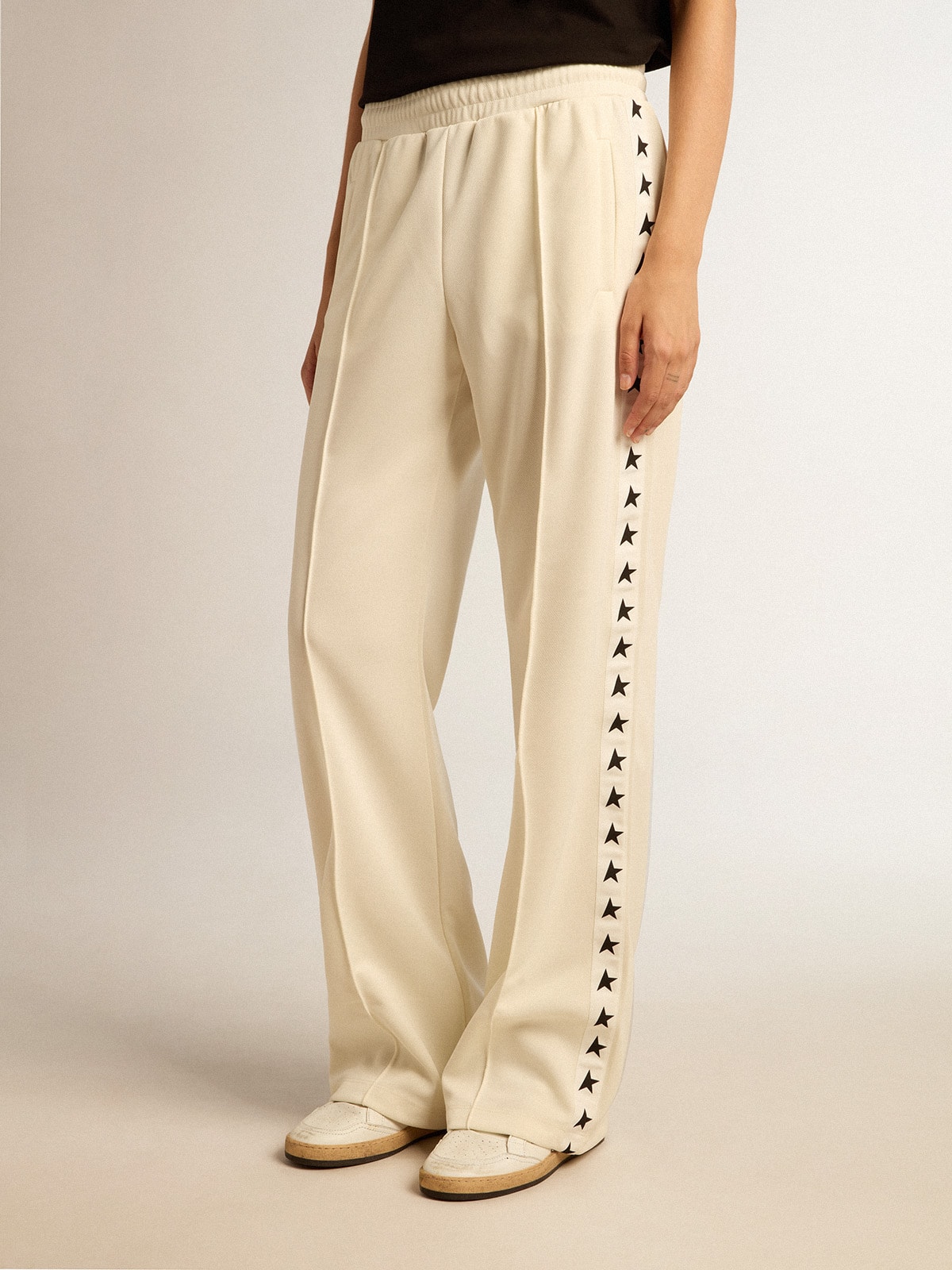 Women's white joggers with stars on the sides
