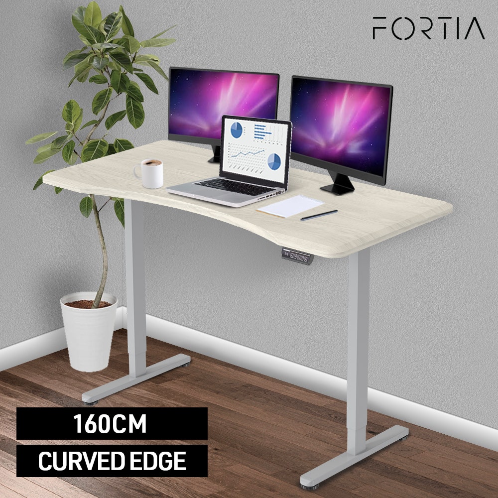 FORTIA Sit To Stand Up Standing Desk, 160x75cm, 72-118cm Electric Height Adjustable, Ergonomically Curved Edge, 50kg Rated, White Oak Style/Silver Frame