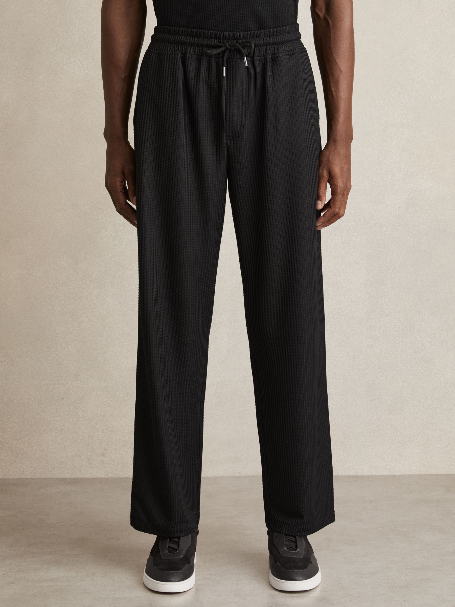 Textured-Knit Tapered Trousers in Black