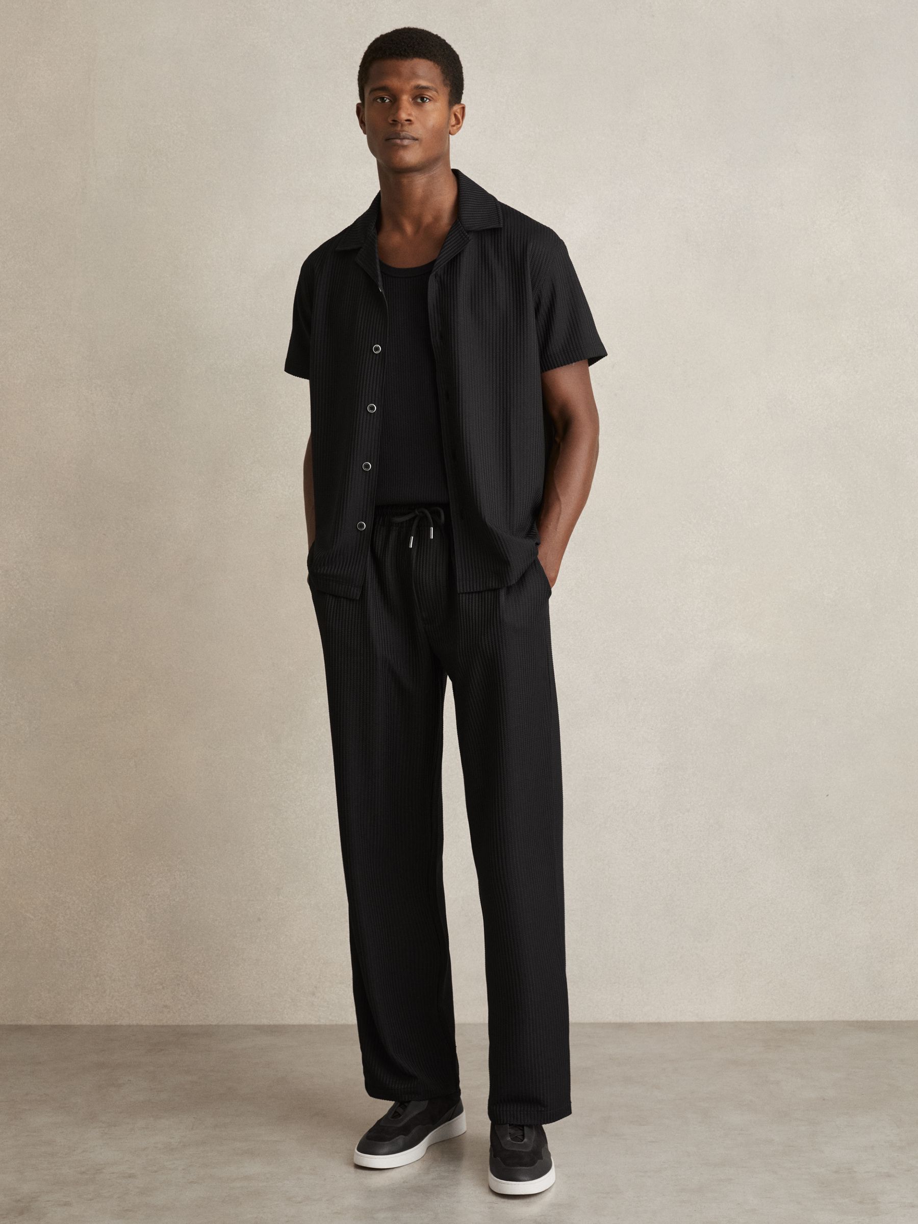 Textured-Knit Tapered Trousers in Black