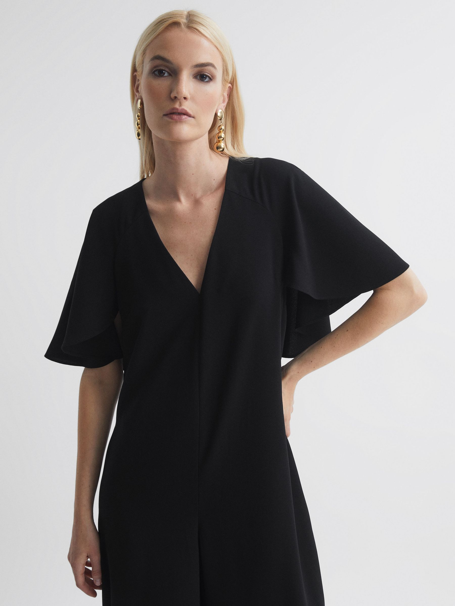 Florere Relaxed Fit Cape Sleeve Jumpsuit in Black