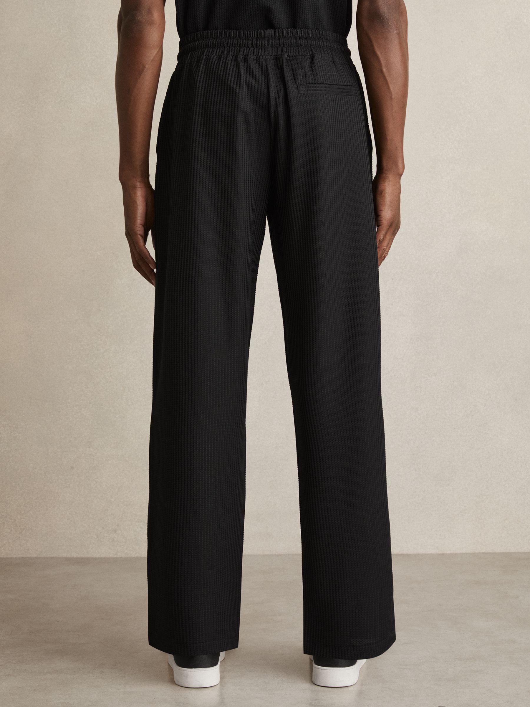 Textured-Knit Tapered Trousers in Black
