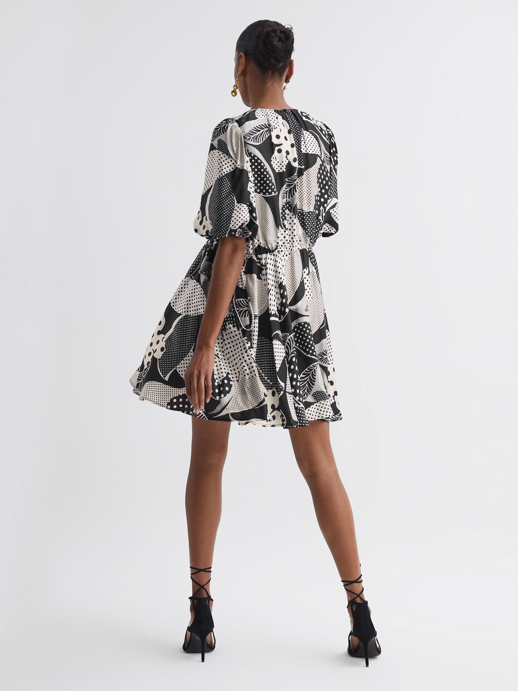 Florere Polka Dot Puff Sleeve Mini Dress in Black