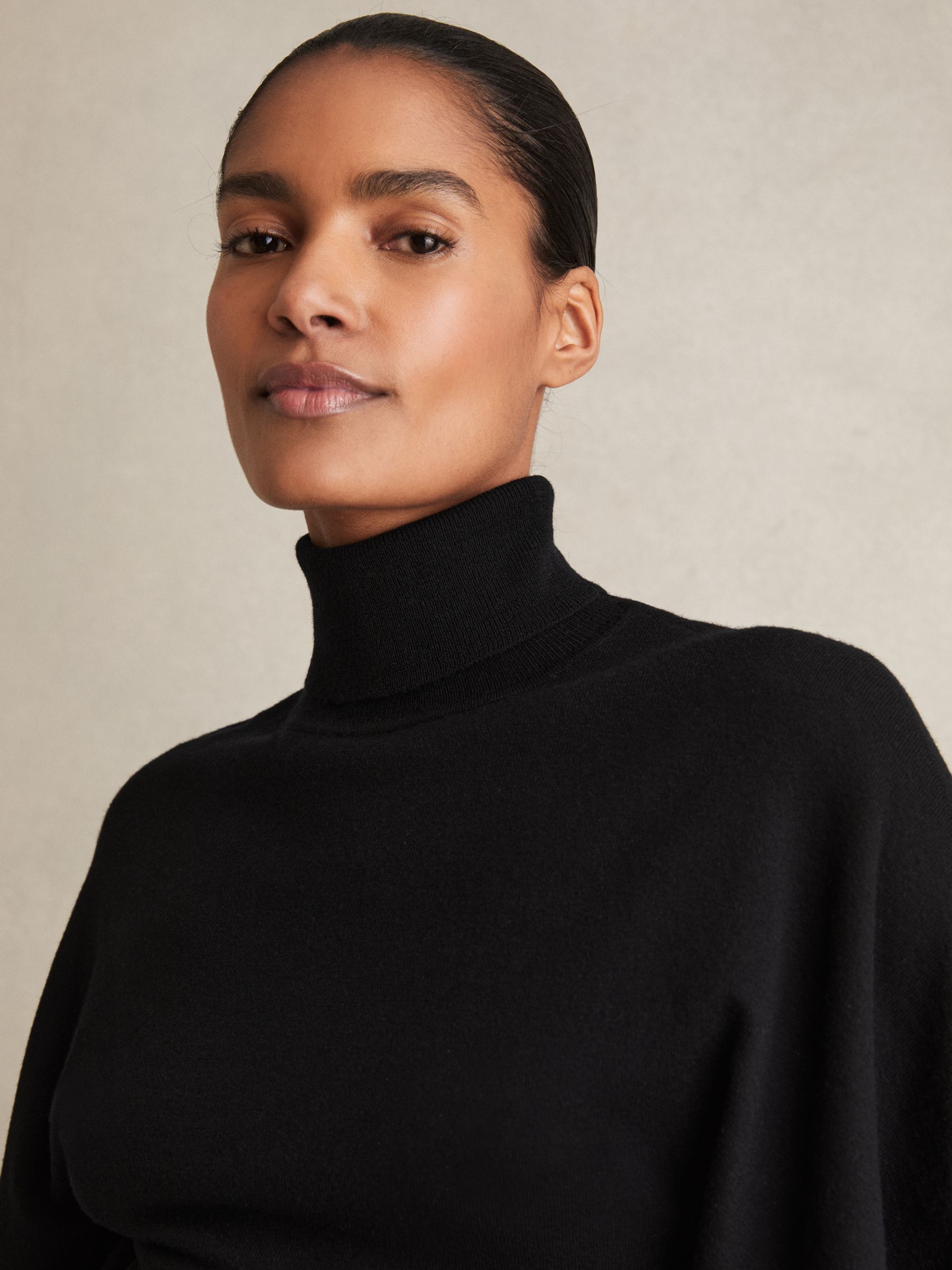 Merino Wool Batwing Roll-Neck Jumper in Black