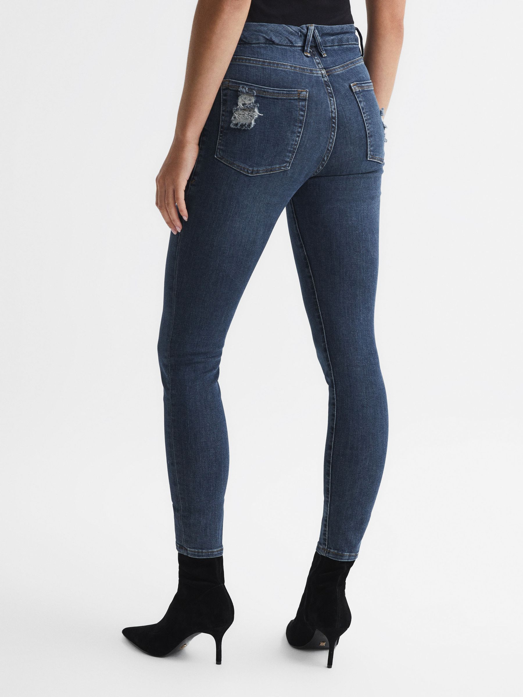 Good American Released Hem Skinny Jeans in Dark Blue