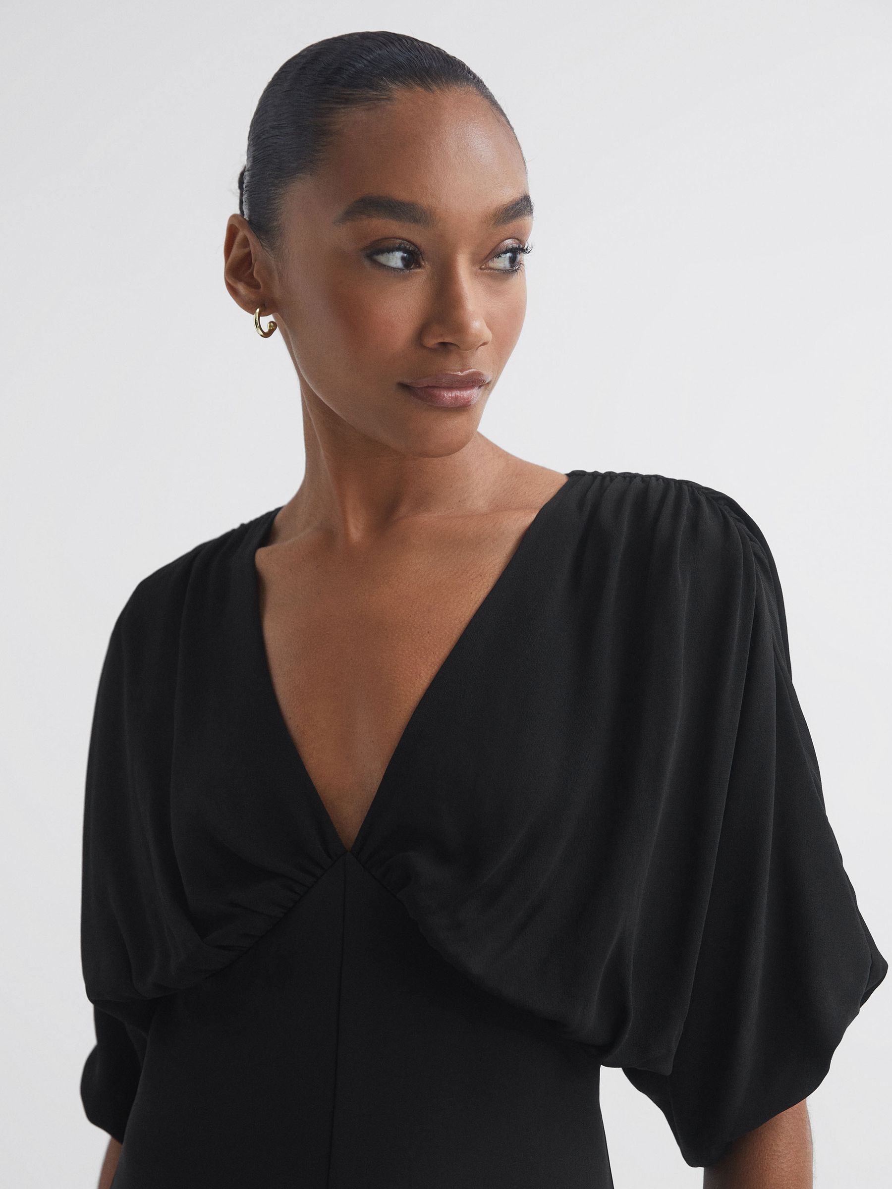 Florere Plunge Neck Wide Leg Jumpsuit in Black