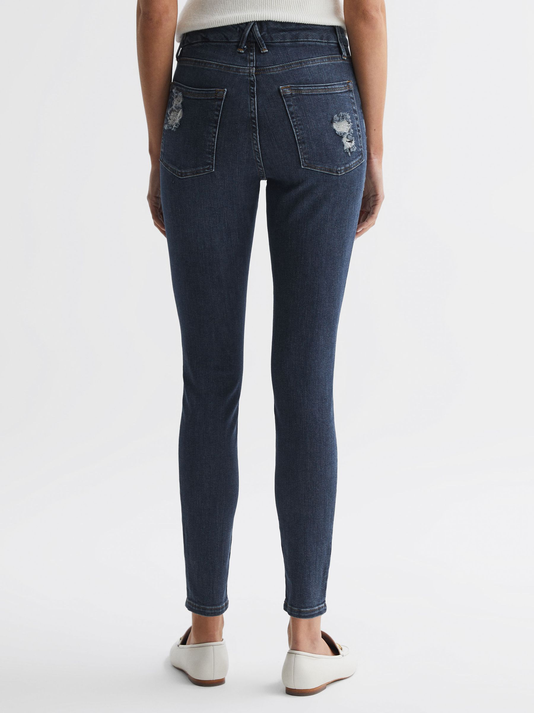 Good American Released Hem Skinny Jeans in Dark Blue