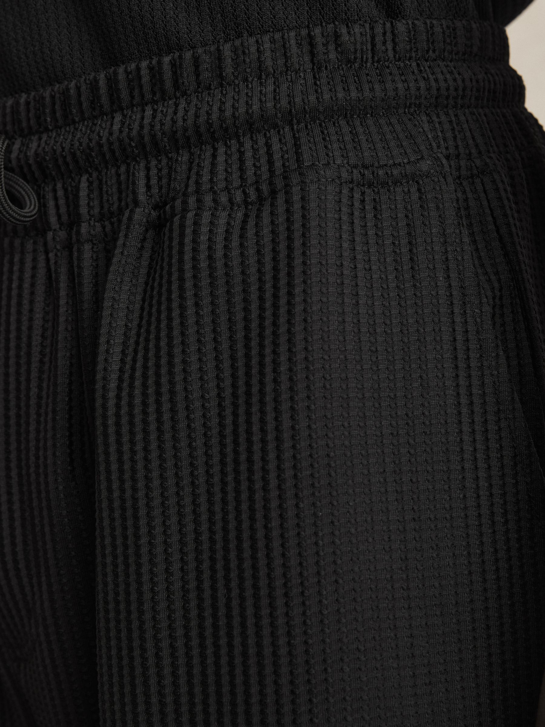 Textured-Knit Tapered Trousers in Black