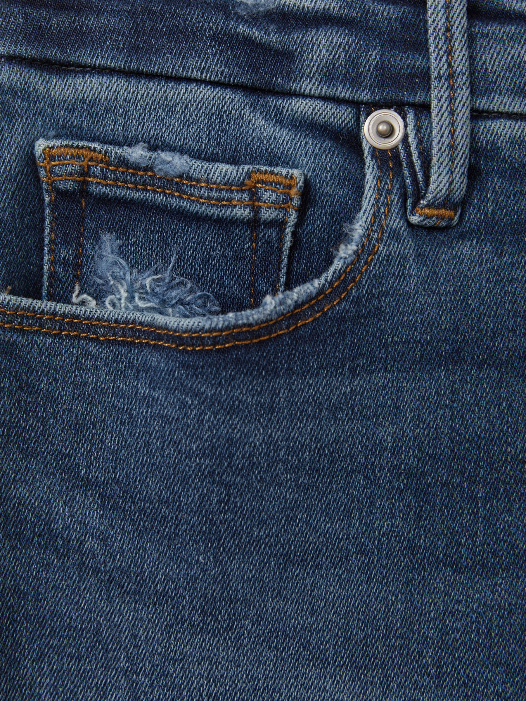 Good American Mid Rise Raw Hem Skinny Jeans in Indigo