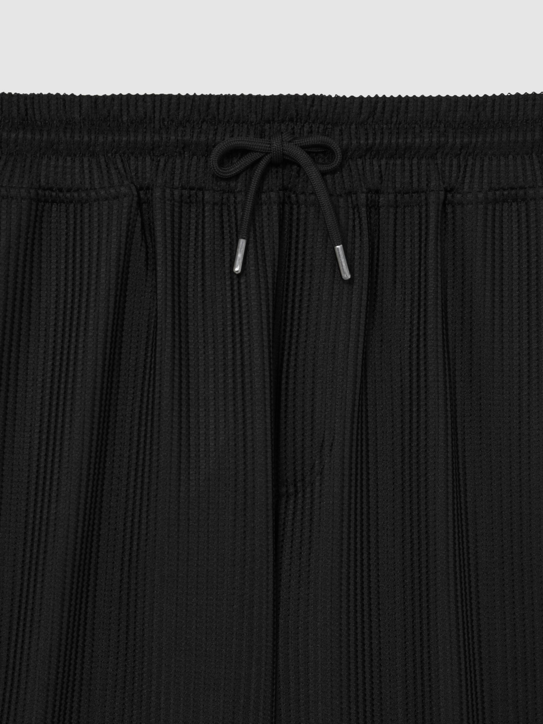 Textured-Knit Tapered Trousers in Black