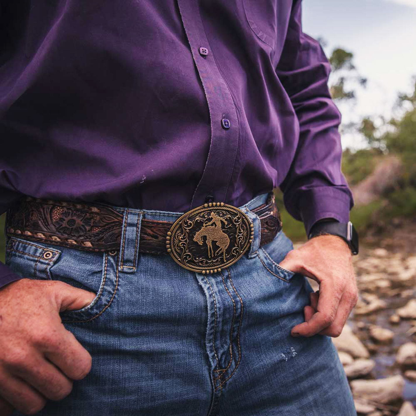 Attitude by Montana Silversmiths Antique Gold with Black Background Gold Bucking Bronc Rider Scrolling and Rope Detail Belt Buckle - Image 1