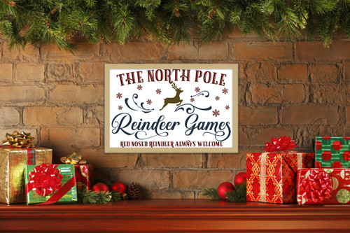 The North Pole Reindeer Games 14.5" x 21.5" Framed Christmas Wall Decor Art Print Sign Poster in a Natural Wooden Frame with UV Acrylic and Hangers