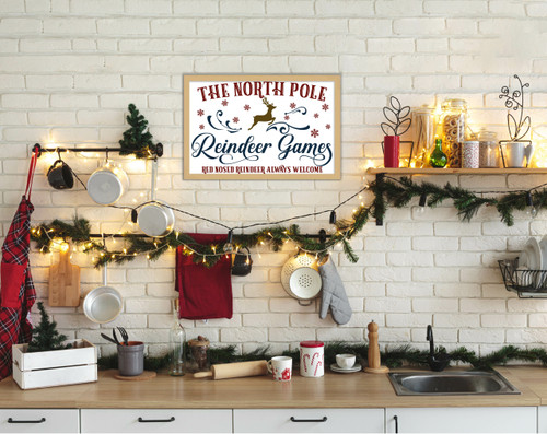 The North Pole Reindeer Games 14.5" x 21.5" Framed Christmas Wall Decor Art Print Sign Poster in a Natural Wooden Frame with UV Acrylic and Hangers