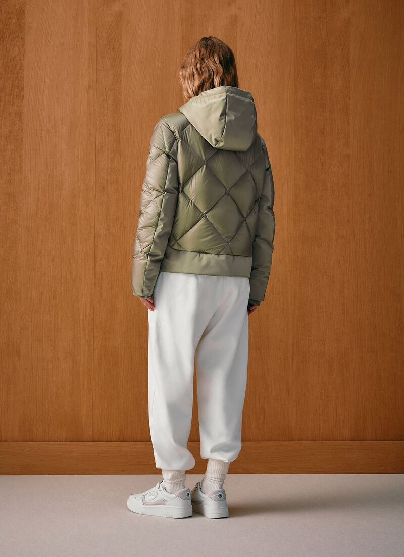 Down jacket with lateral side zip closure.