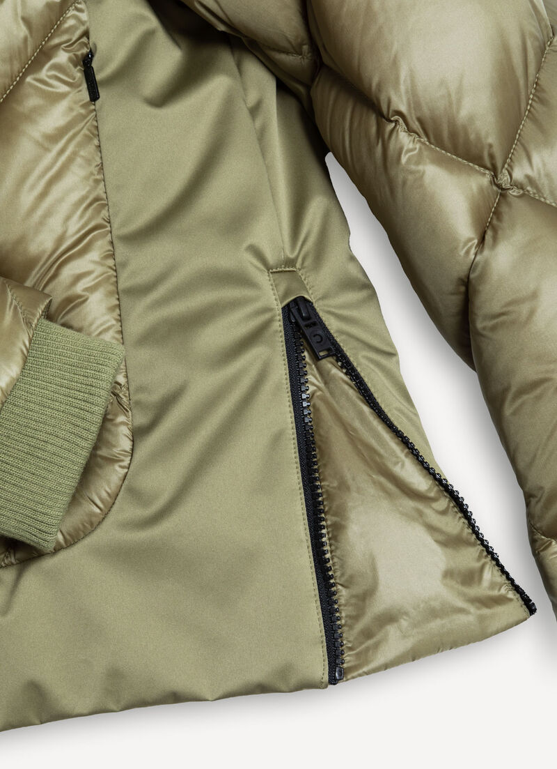 Down jacket with lateral side zip closure.