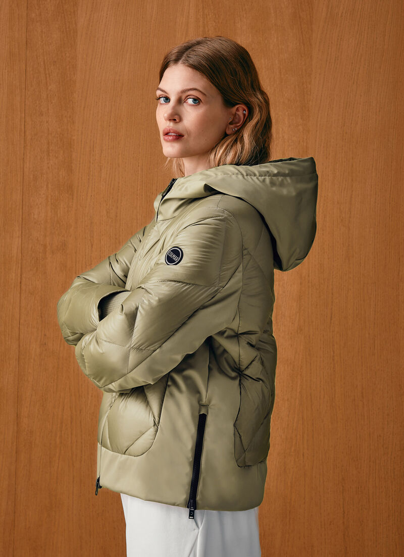 Down jacket with lateral side zip closure.
