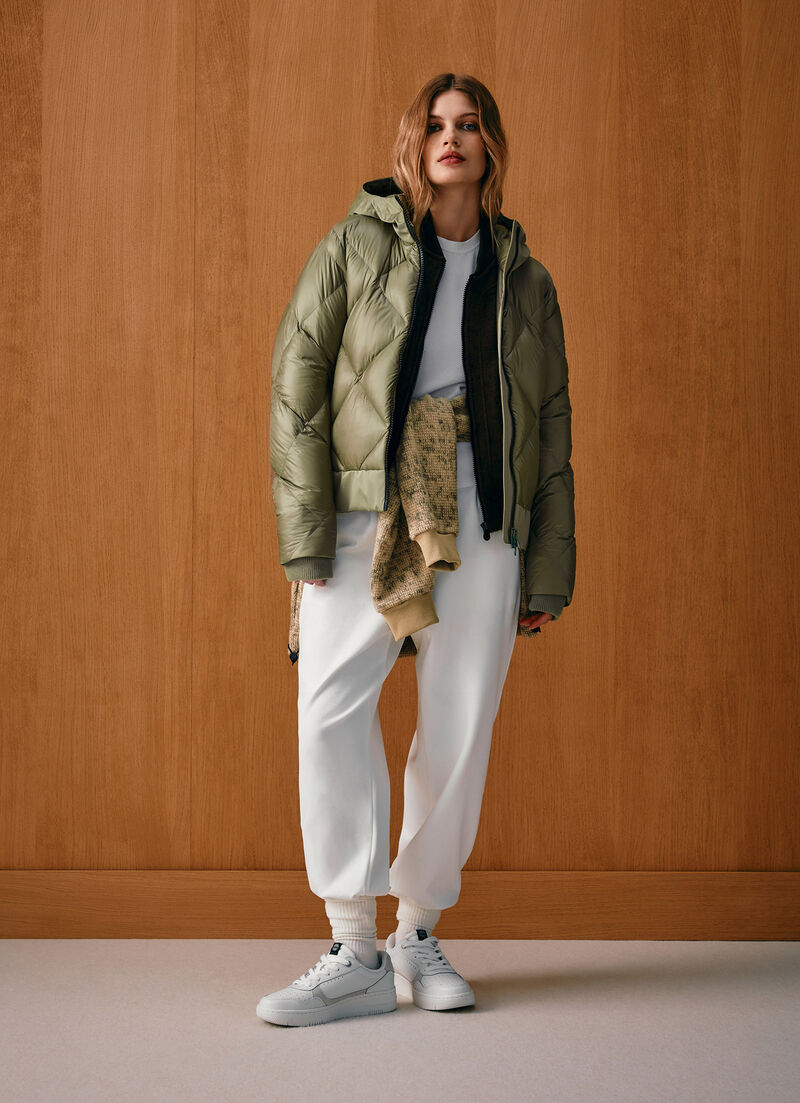 Down jacket with lateral side zip closure.