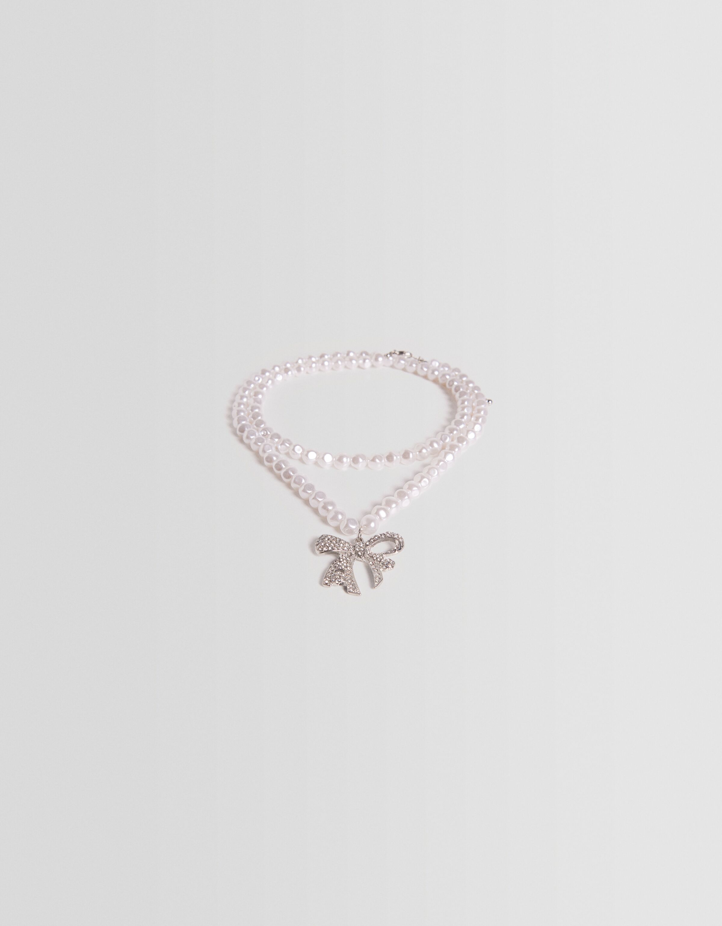 Collar perlas lazo pedrería