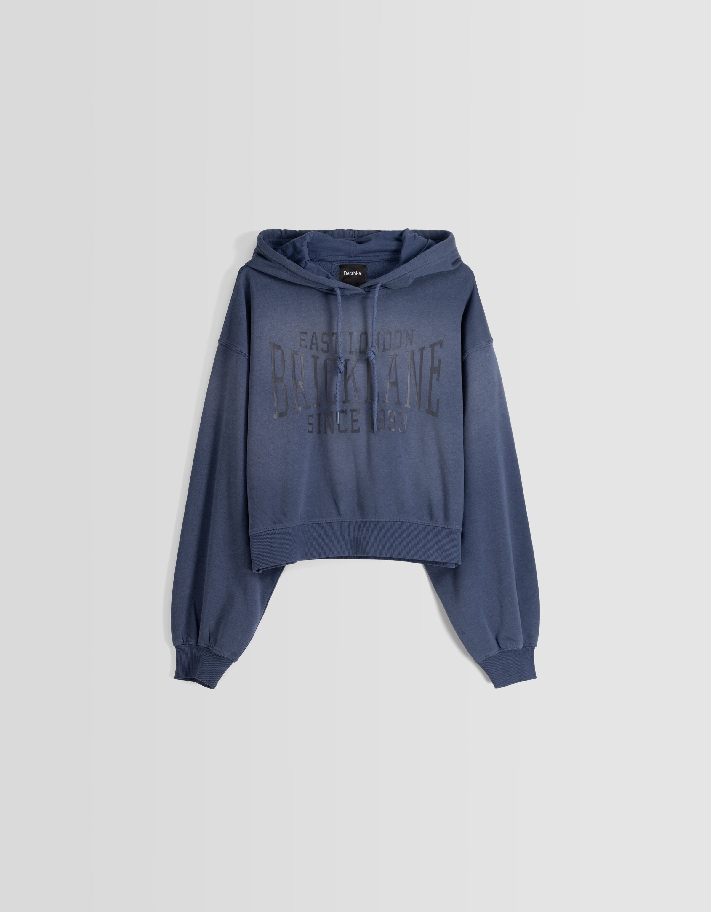 Sudadera capucha oversize efecto lavado texto