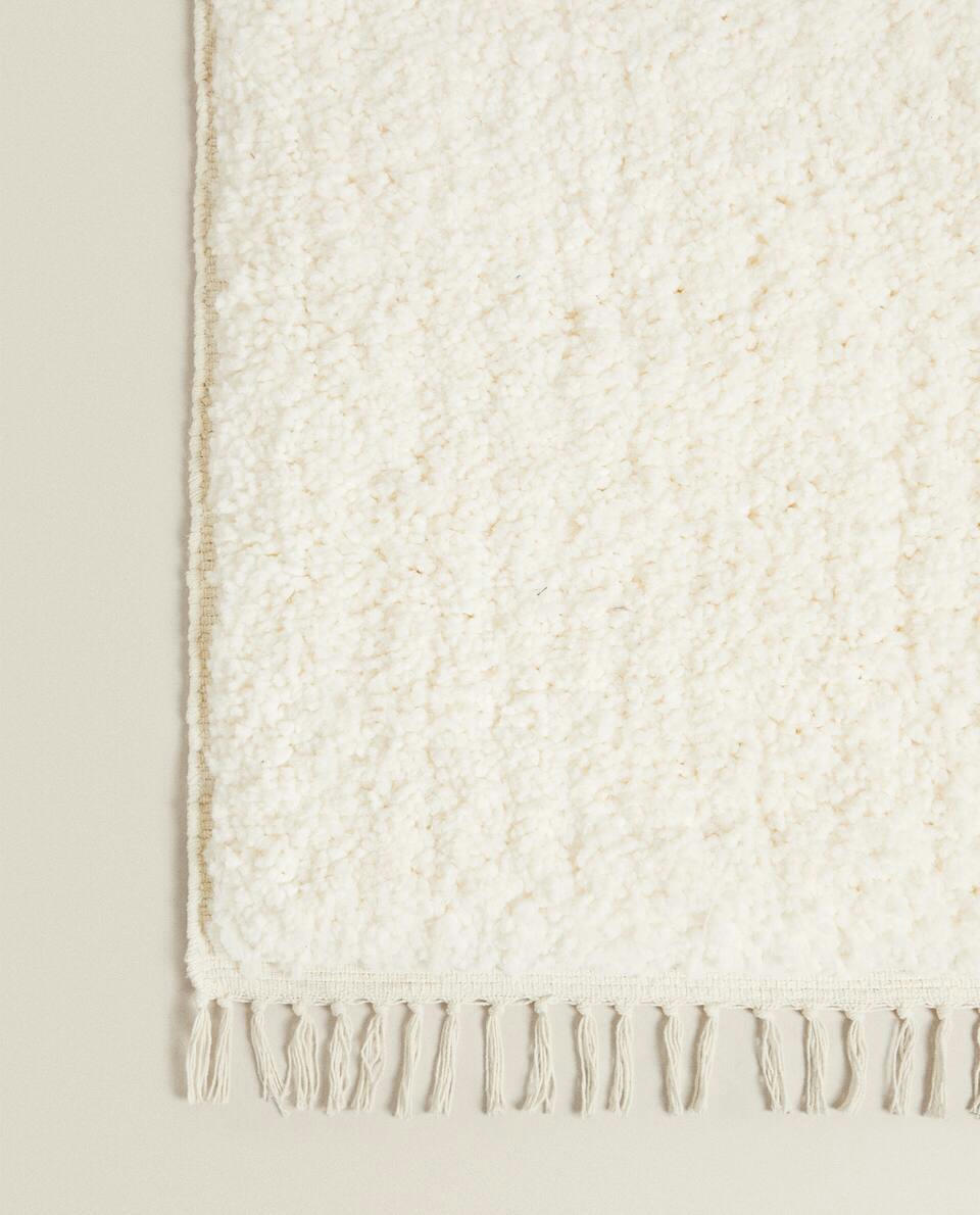 TEXTURED RUG WITH FRINGING