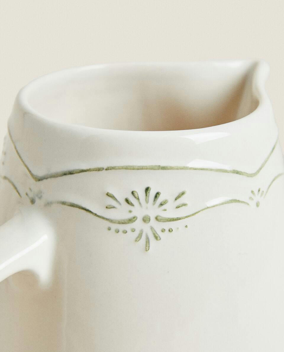 EARTHENWARE JUG WITH RAISED CHRISTMAS DESIGN