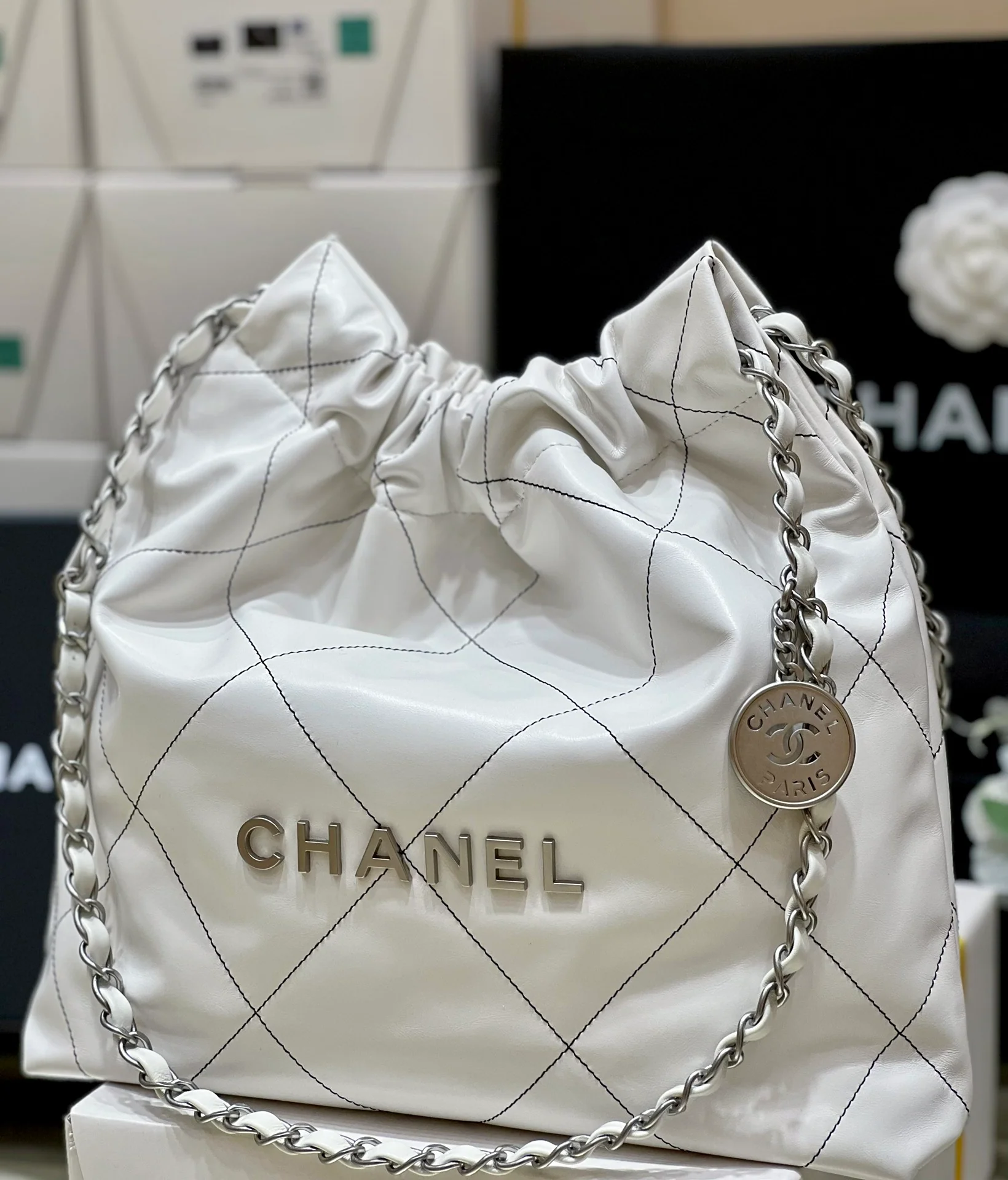 Сумка Chanel из круизной коллекции 2023 года - модель 22bag - белая с черной строчкой.